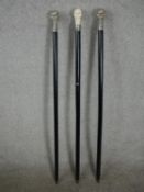 Three 20th century walking canes with skull head finials. H.97 W.4cm.