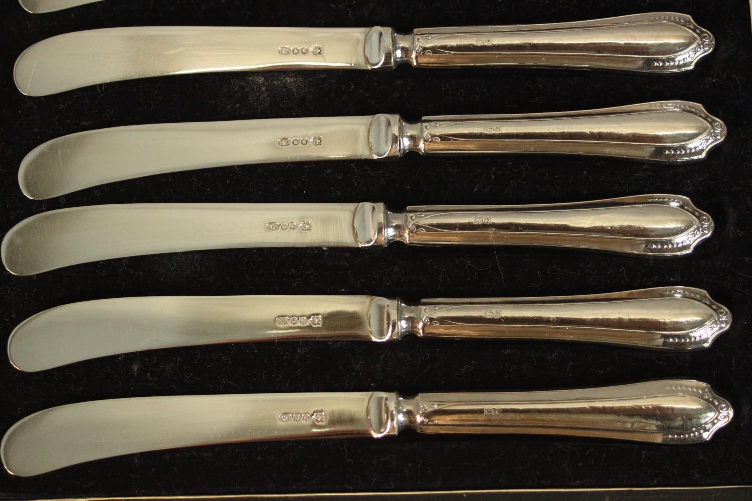A leather cased set of coffee spoons and sugar tongs by Walker and Hall along with a cased set of - Image 6 of 9