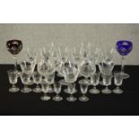 A collection of twenty seven stemmed cut crystal glasses, including two bohemian cut to clear