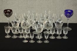 A collection of twenty seven stemmed cut crystal glasses, including two bohemian cut to clear