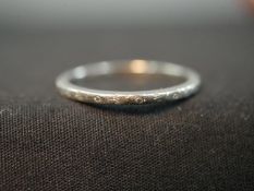 An Art Deco engraved slim platinum wedding band. Stamped PLATINUM. With an antique brooch box.