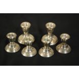 Three pairs of weighted silver candlesticks, various makers, two small pairs and one larger. H.7 W.