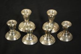 Three pairs of weighted silver candlesticks, various makers, two small pairs and one larger. H.7 W.