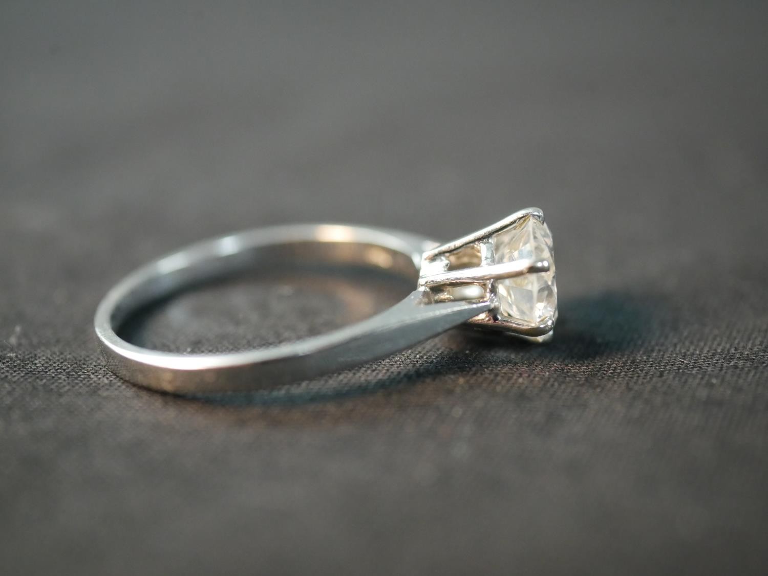 An 18 carat white gold solitaire diamond ring, set with a round old cut diamond in an open back - Image 4 of 7