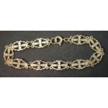 A 9ct yellow gold pierced cross design articulated panel bracelet with secure C-sprung clasp.