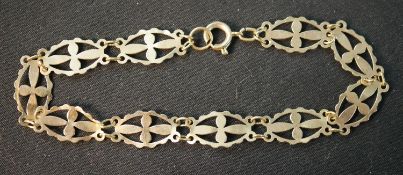 A 9ct yellow gold pierced cross design articulated panel bracelet with secure C-sprung clasp.