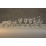 A collection of twenty three cut crystal and glass drinking glasses, including a set of nine cristal