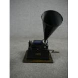 A Thomas A Edison Gem phonograph with 12cm cylinder, key and black painted tin horn. H.40 W.27 D.