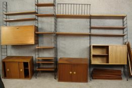 An extensive 1960's Brianco teak modular wall unit, in the manner of Ladderax, comprising black