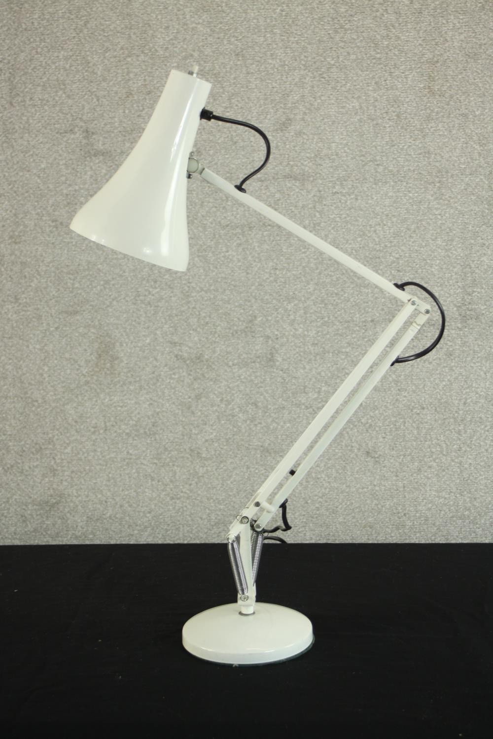 A mid 20th century Herbert Terry style anglepoise desk lamp, in white with a circular base. H.85