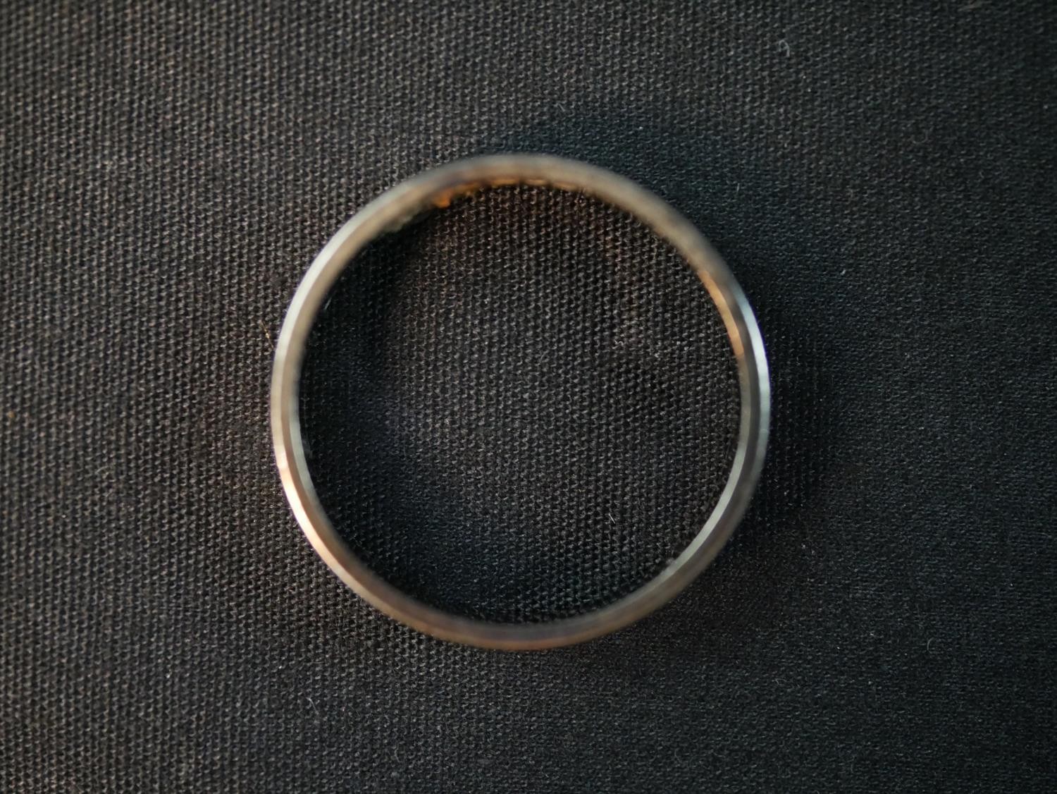 An 18ct white gold wide flat wedding band. Stamped 18, London. Weight 4.11g. Ring size O. - Image 2 of 4