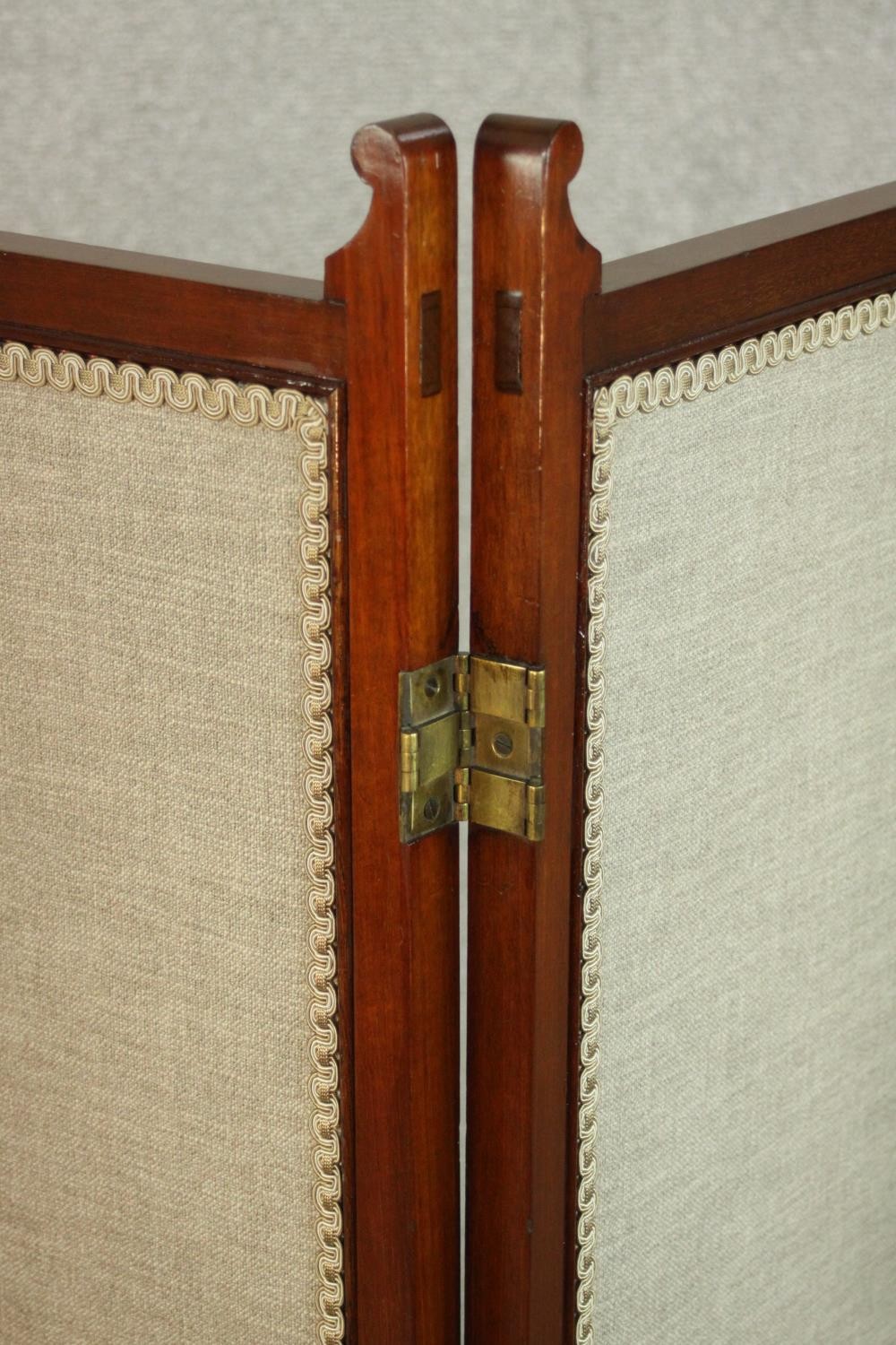An Edwardian walnut fourfold screen, each panel upholstered with an oatmeal coloured fabric, with - Image 8 of 10