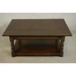 A 17th century style stained oak coffee table, the rectangular top on turned and block legs joined