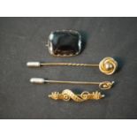 A collection of yellow metal and gold jewellery, including a 9ct art nouveau stick pin, a rolled