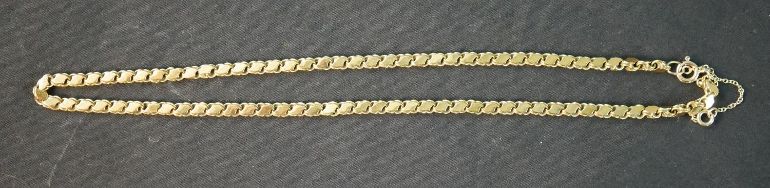 A 16 inch fancy s-link yellow metal (tests as 14ct) chain with a pair of matching earrings. The