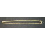 A 16 inch fancy s-link yellow metal (tests as 14ct) chain with a pair of matching earrings. The