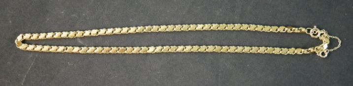 A 16 inch fancy s-link yellow metal (tests as 14ct) chain with a pair of matching earrings. The