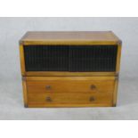 A late 20th century Chinese hardwood side cabinet, with a pair of sliding grille doors, above two