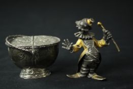 A gilded silver miniature statue of a clown stamped 800 along with a Dutch repousse miniature basket