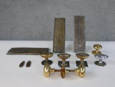 A collection of early 20th century brass and copper door decorations including a number of door