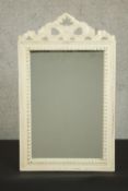 A white painted carved framed bow motif wall mirror. H.67 W.40cm.