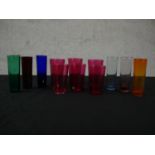 A collection of twelve coloured glasses, including a set of six Victorian cranberry glass cordial