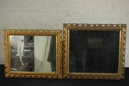 A near pair of early 20th century gilt wall mirrors, of rectangular form, the frames with pierced