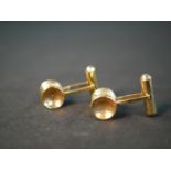A pair of Russian yellow metal (tests higher than 9ct) hammered dumb bell form cufflinks with hinged
