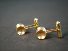 A pair of Russian yellow metal (tests higher than 9ct) hammered dumb bell form cufflinks with hinged