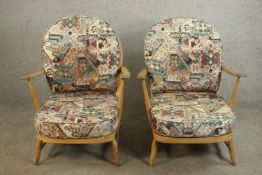 A pair of Ercol elm and beech hoop back armchairs, in Windsor style, with loose back and seat