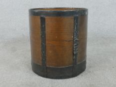 An early 20th century oak peat or coal bucket, of cylindrical form with iron banding. H.32 Diam.30.