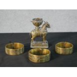 A 19th century Indian Nandi brass horse incense holder along with three brass bangles with incised