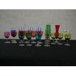 A collection of 19th and 20th century coloured glass, including three cranberry glass small wine