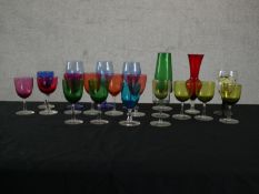 A collection of 19th and 20th century coloured glass, including three cranberry glass small wine