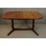 A 1960s Rasmus vintage Danish rosewood extending dining table with two extra leaves on stretchered