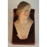 An Italian 19th century hand painted ceramic female head with brown hair and brown eyes, rests on