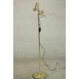 A polished brass adjustable twin spotlight floor standing lamp. H.144 Dia.27cm.