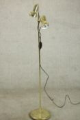 A polished brass adjustable twin spotlight floor standing lamp. H.144 Dia.27cm.