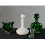 A green and white swirl art glass decanter and circular stopper. a frosted white opaque glass
