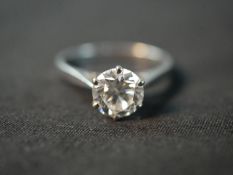 An 18 carat white gold solitaire diamond ring, set with a round old cut diamond in an open back