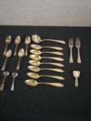 A collection of silver cutlery, including an Ionian silver caddy spoon, a set of seven German gilded