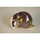 A Royal Crown Derby porcelain paperweight in the form of a badger, in the Imari palette with