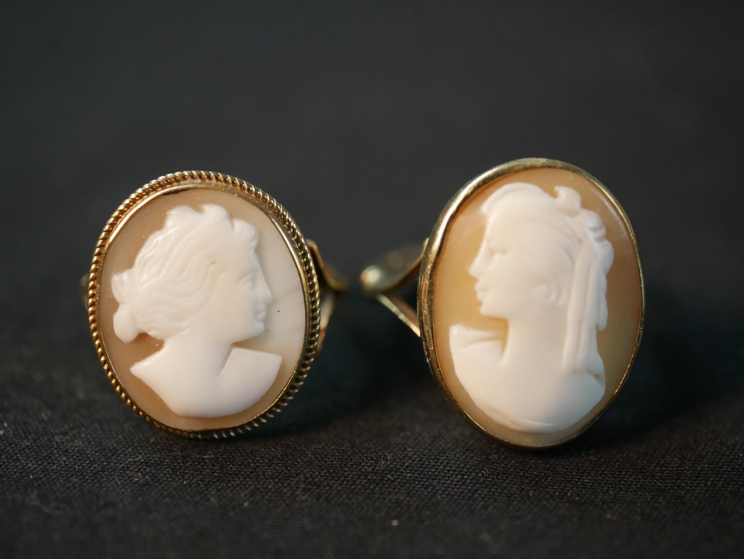 Two 9ct gold carved shell cameo dress rings, each of a classical female side portrait. One with a