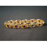 An Art Nouveau spiral design Murrle & Bennet 9ct yellow gold articulated panel bracelet, set with