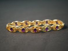 An Art Nouveau spiral design Murrle & Bennet 9ct yellow gold articulated panel bracelet, set with