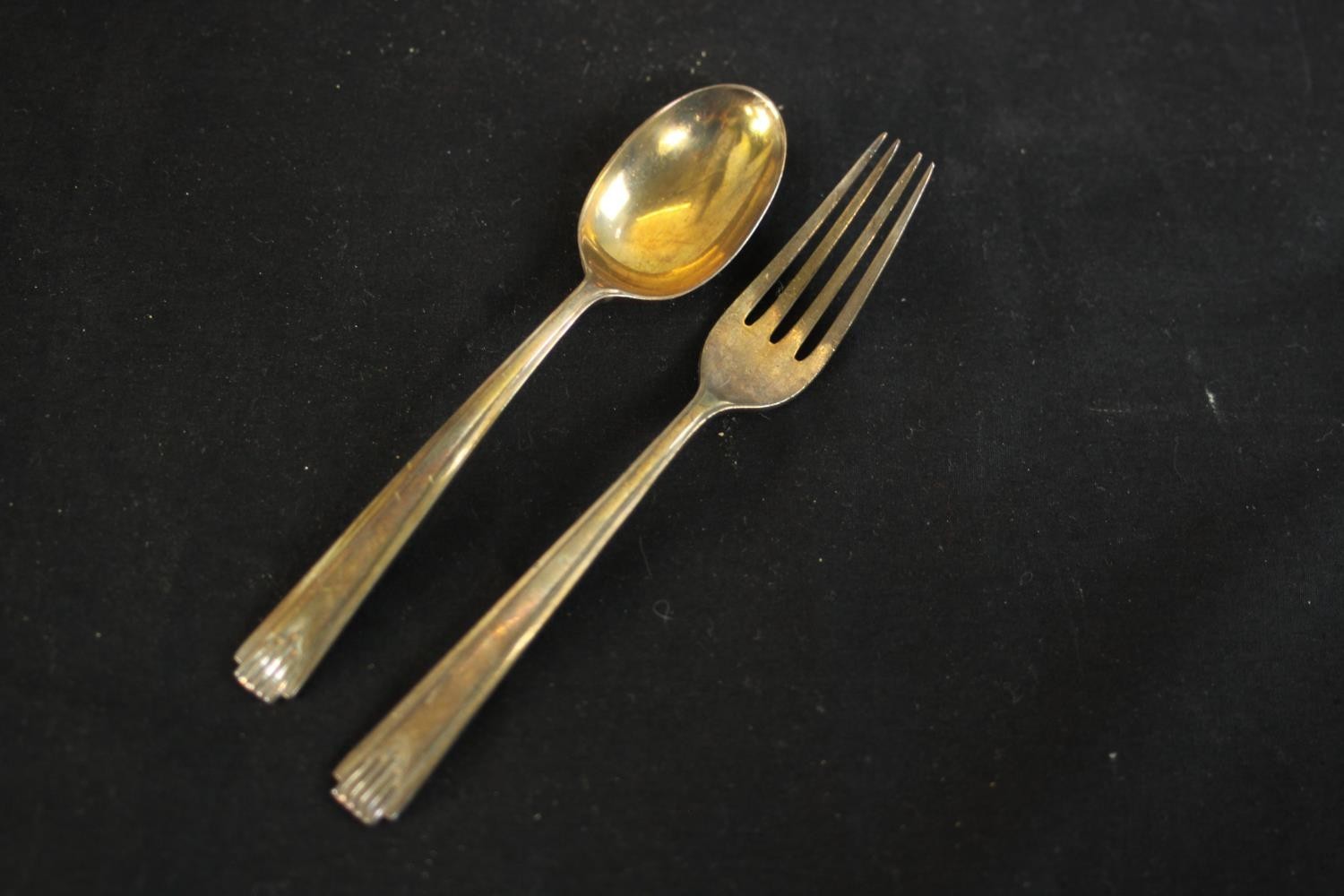 Two pairs of gilded silver plated berry spoons and a cased set of silver child's spoon and fork. ( - Image 4 of 8