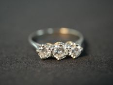 An Edwardian platinum and diamond three stone diamond ring, set to centre with a round old cut