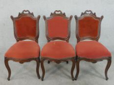 A set of three late 19th/early 20th century French walnut Louis XV style dining chairs,