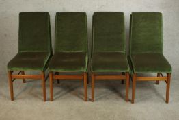 A set of four circa 1960s teak dining chairs, upholstered in green velour on tapering legs joined by