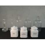 Three clear glass pharmaceutical demijohns along with a pair of cut glass decanters and three
